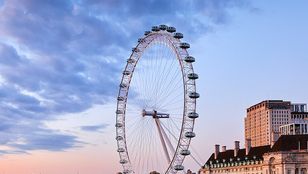 Breathtaking sunset view of Thames River and Ferris Wheel, creating a picturesque scene of London's beauty and tranquility.